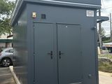 a portable toilet in a parking lot next to a parking lot