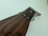 a knife that is laying on top of a cutting board
