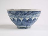 a blue and white bowl sitting on a white surface