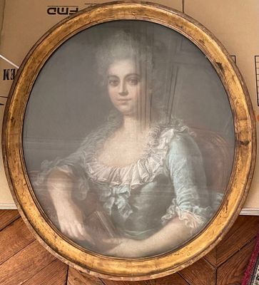 a picture of a woman sitting in a chair in a room