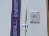 a picture of a necklace and a ruler on a table