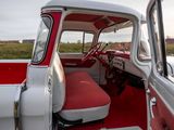 a red and white truck with a red seat in the back