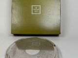 an image of a silver plate with a green box in the background