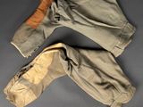 an old pair of pants sitting on top of a gray surface