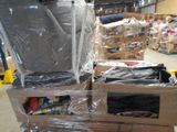 a pile of luggage sitting on top of a pallet in a warehouse