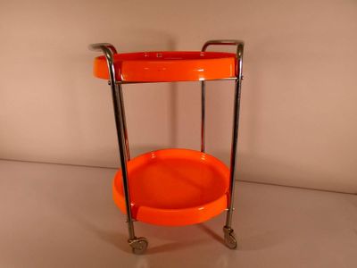 an orange trolley that is sitting on a white surface