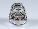 an image of a diamond and sapphire ring on a white surface