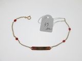 a close up of a bracelet with a tag attached to it