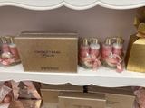 a shelf with a lot of perfume bottles and boxes on it