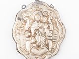 an image of a silver pendant with a picture of jesus on it
