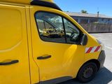 the yellow van is parked in a parking lot with a surfboard on top of it