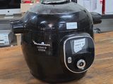 a black air fryer sitting on a wooden table
