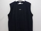 a black shirt hanging on a hanger on a wall