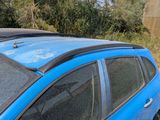 a blue car that is parked on the side of the road