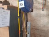 a blue hose attached to a metal pole in a room