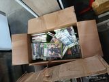 a cardboard box full of dvds on a table