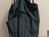 denim overalls hanging on a hanger in front of a door