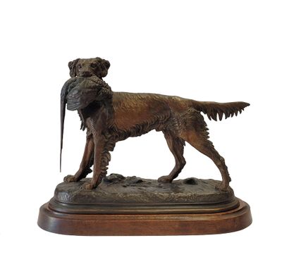 statue of a dog with a pheasant in its mouth on a wooden base