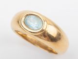 an image of a gold ring with a blue topaz stone