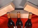 three bottles of wine sitting next to each other on a table