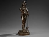 a bronze statue of a man holding a sword and a staff