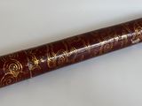 un vieux livre orné d'inscriptions dorées, posé sur une surface blanche