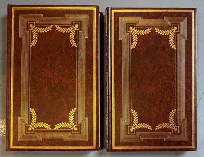 pair of antique leather bound books with gold leaf decoration