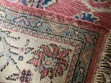 a cat that is sitting on a rug on the floor