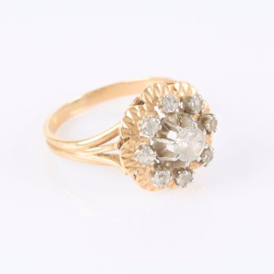 a close up of a diamond ring on a white surface