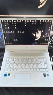 un ordinateur portable blanc posé sur une table noire