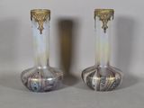 two vases that are sitting on a table