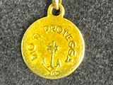 a close up of a gold coin on a gold chain