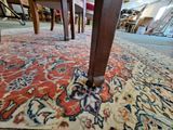 a rug on the floor in a room with a table and chairs