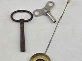 two keys and a keychain on a white surface