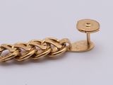a close up of a gold chain link on a white background