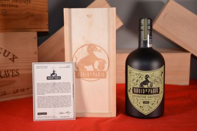 a bottle of wine sitting next to a wooden box
