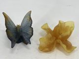 two butterflies that are sitting next to each other on a table
