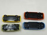 four different colors of batteries on a table with a white background