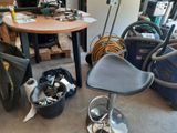 a chair and a table in a room with many tools