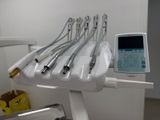 five dental instruments sitting on a stand in a room