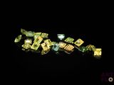 a close up of a bunch of yellow diamonds on a black surface