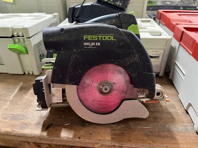 someone is using a circular saw to cut a piece of wood