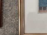 a picture of a cat that is sitting in front of a picture of a cat