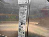 a stainless steel oven that has a sign on it
