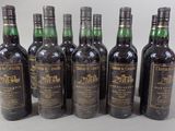 six bottles of wine are lined up in a row on a table