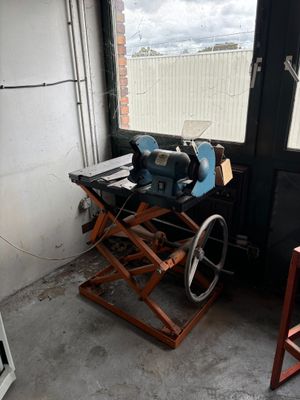 a table with a sewing machine on it in front of a window