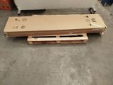 a box and pallet sitting on the floor next to a refrigerator