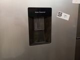 an image of a stainless steel refrigerator with a water dispenser