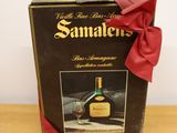 a bottle of wine in a box with a red bow