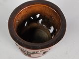 a small brown bowl sitting on top of a white table